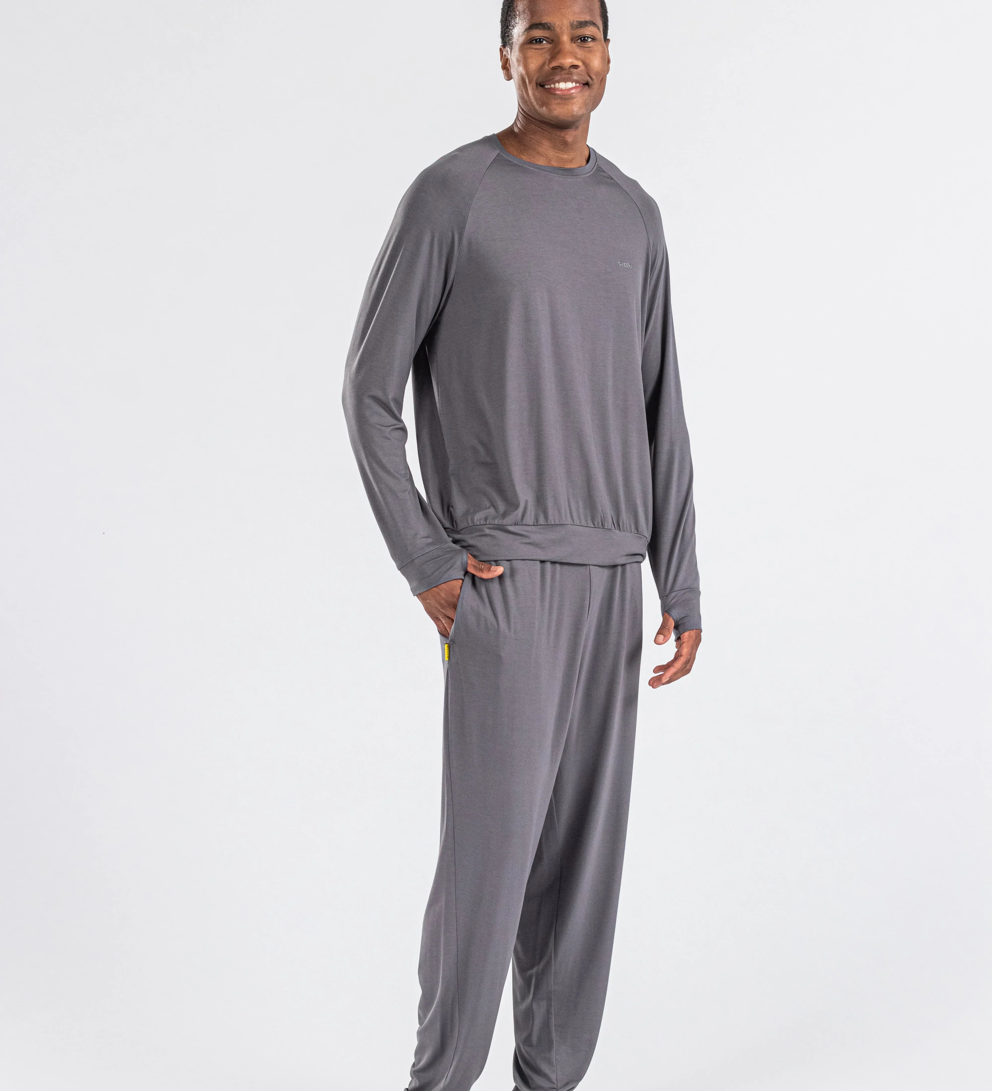 Man modeling charcoal gray men's loungewear set on white background