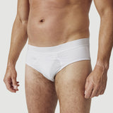 Man wearing white cotton briefs, front view, with neutral background