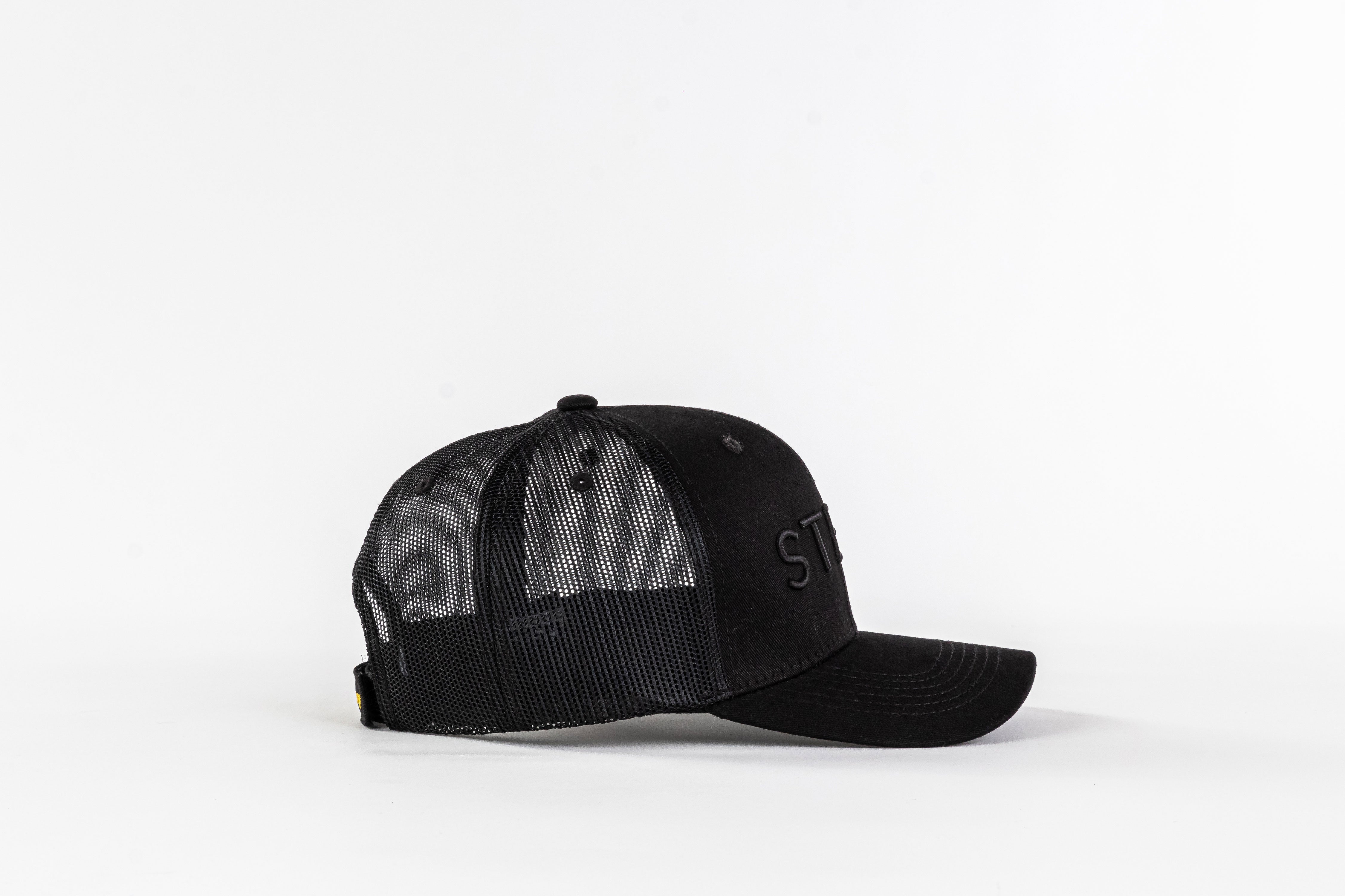 Black mesh trucker hat with curved brim on white background