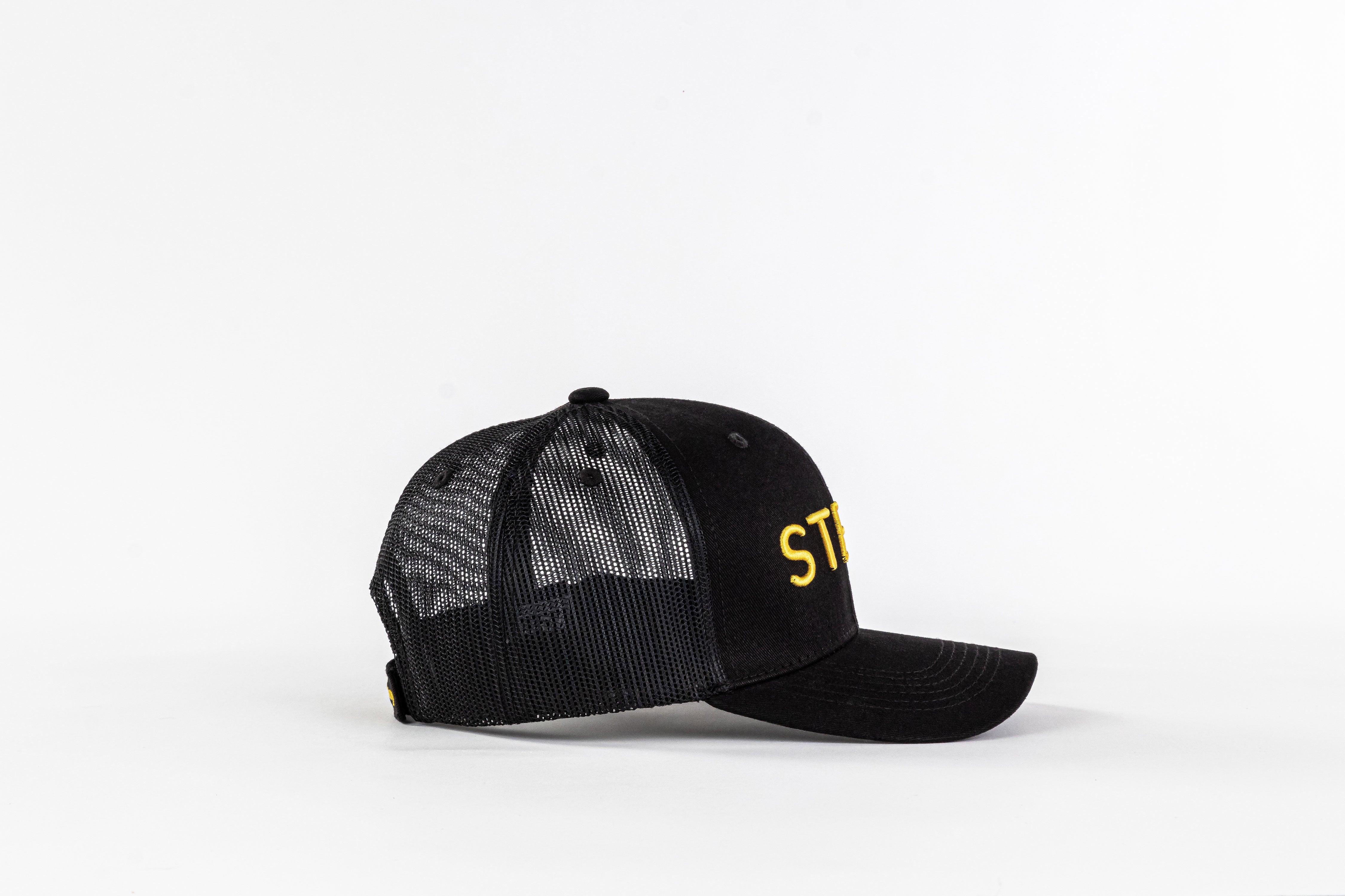 Black mesh trucker hat with yellow 'STE' embroidery on white background