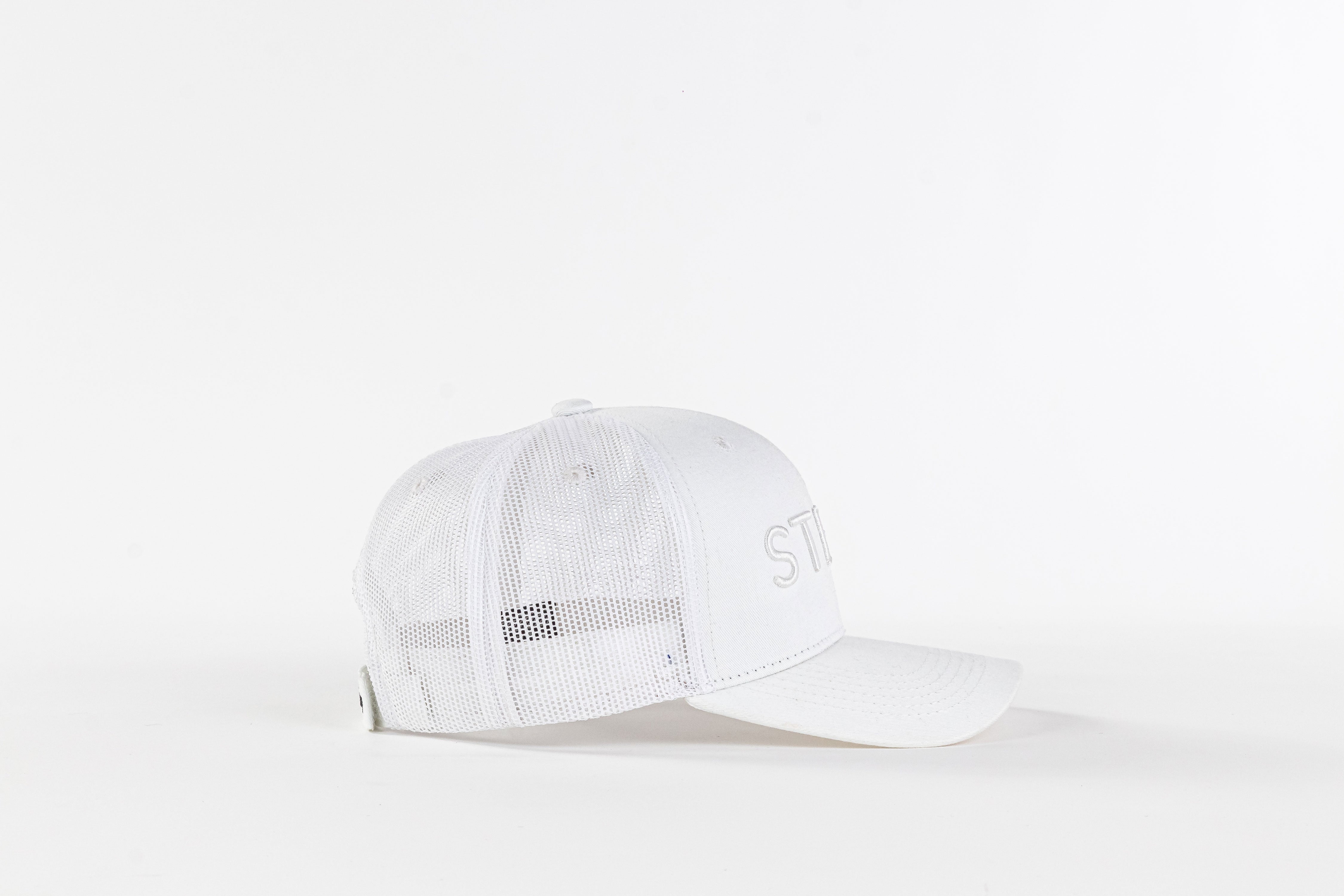 White mesh trucker hat with curved brim on a plain white background