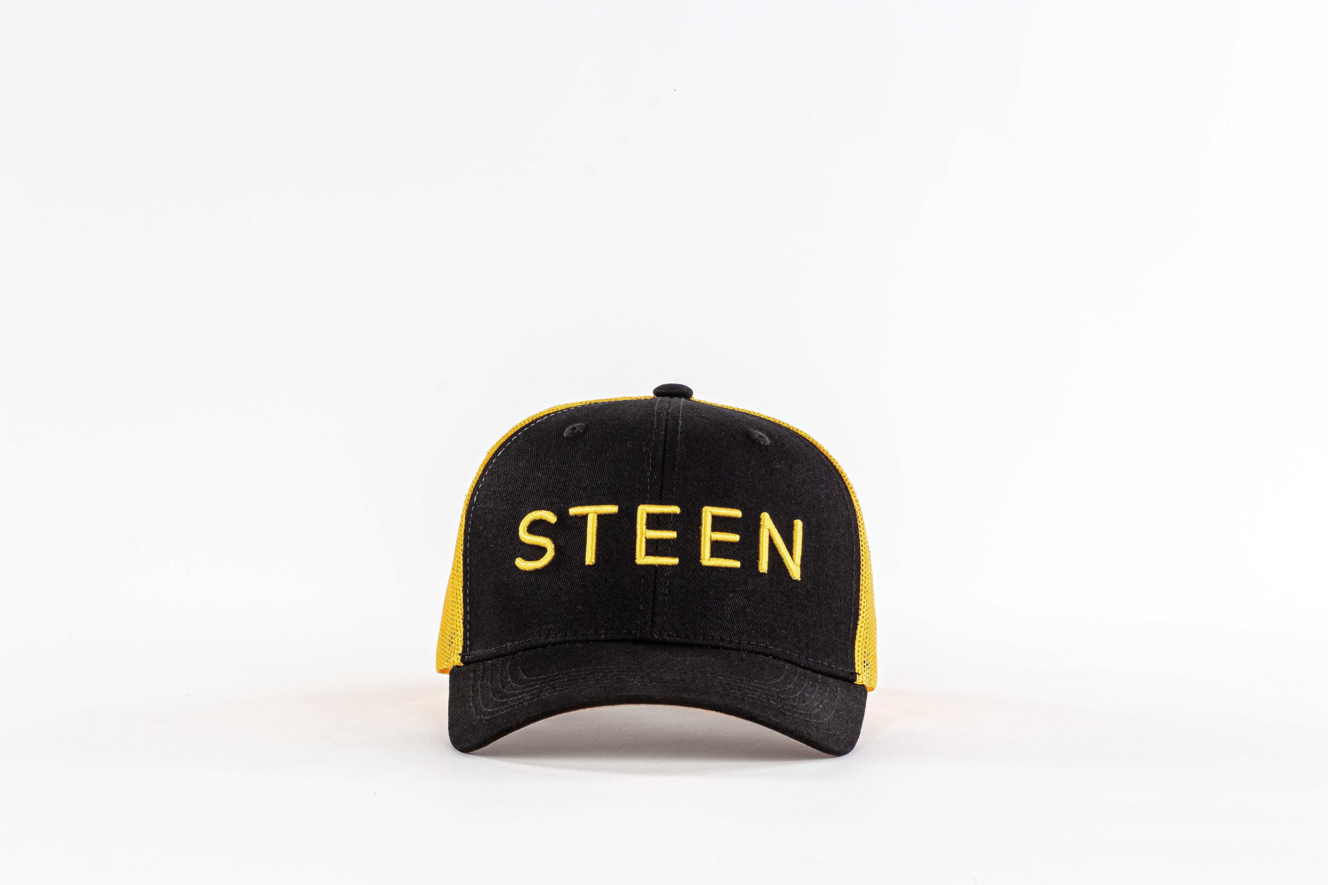 Black and yellow STEEN trucker hat with mesh back on white background