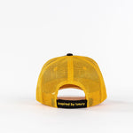 Yellow mesh trucker hat back view with 'inspired by luxury' text on black strap