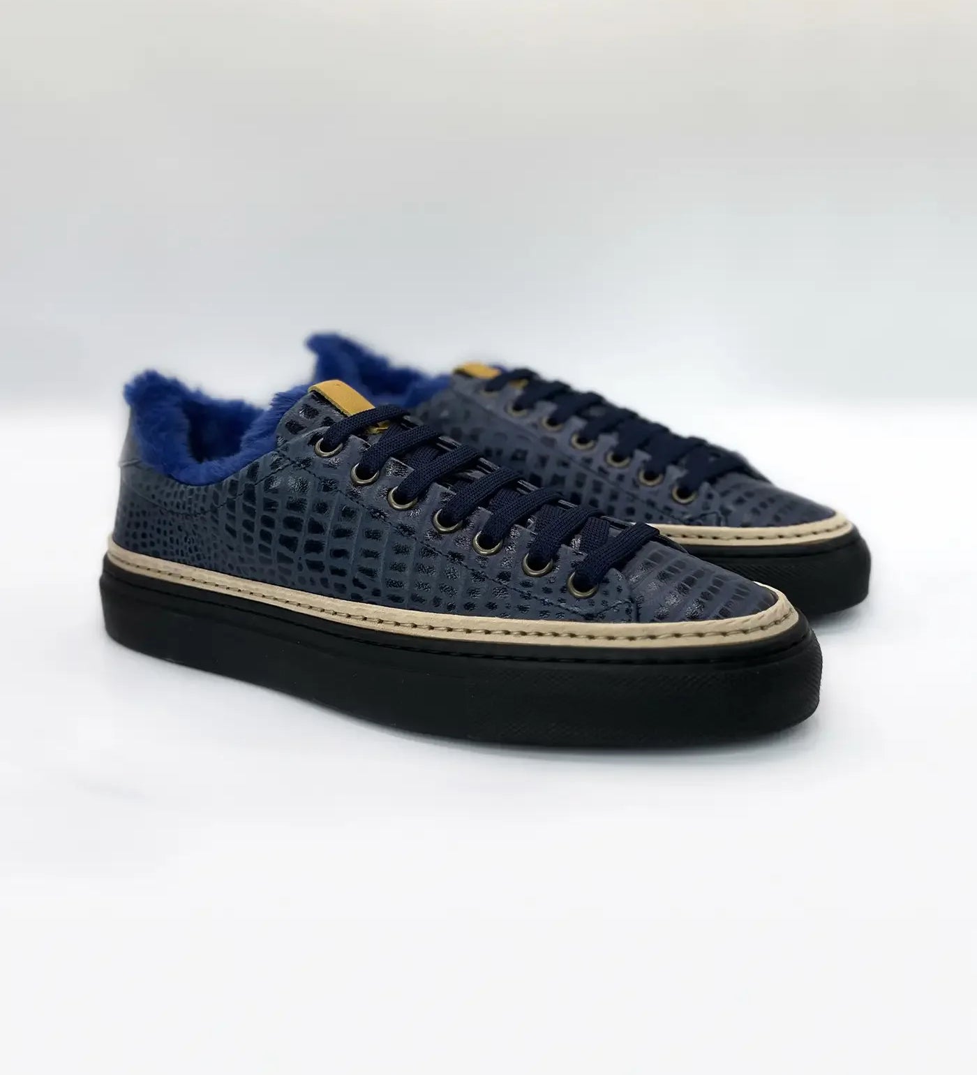 Navy blue men's sneakers with textured pattern, black soles, and blue fur lining