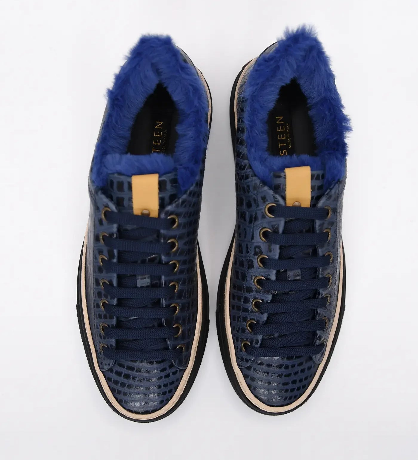 Navy blue men's sneakers with faux fur lining and textured leather pattern, top view